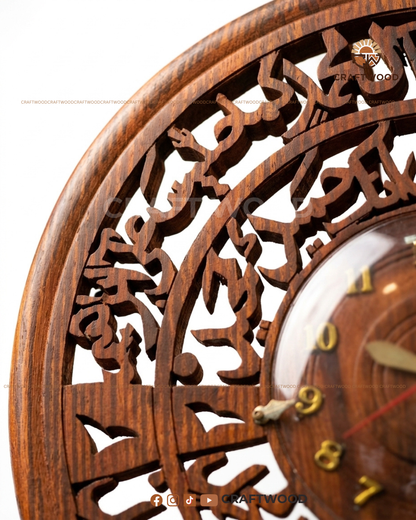 Wooden wall clock with intricate carvings and visible brand logo.