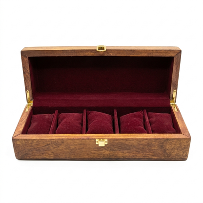An open wooden watch box with a dark reddish-brown wood grain exterior and a deep burgundy velvet interior, featuring five individual watch cushion compartments and gold-tone metal latches.
